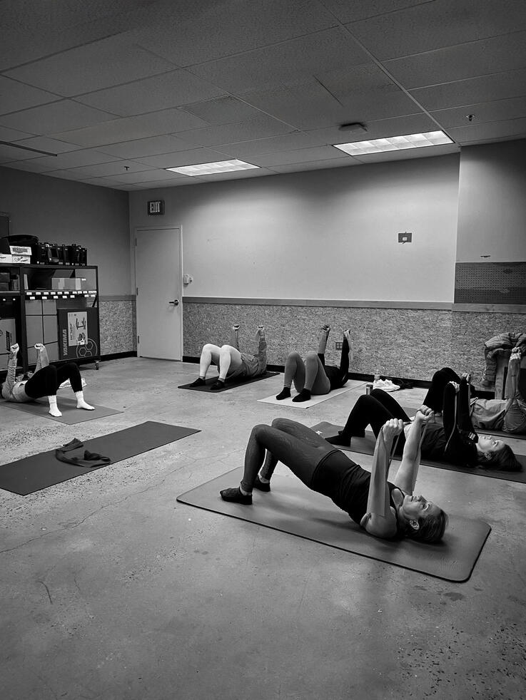 Movement & Alignment Participants performing bridge exercises during BACK TO THE MAT Vol. 001 at REI East Hanover