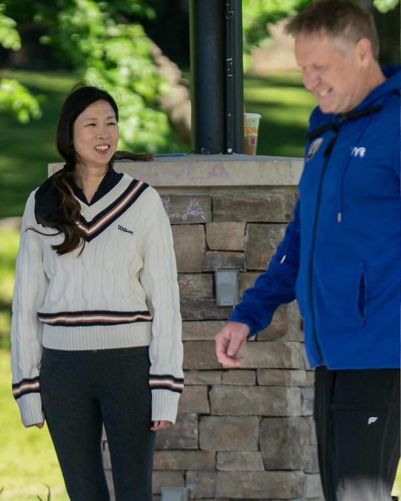 In Between Participants conversing beneath the gazebo between exercises during class.