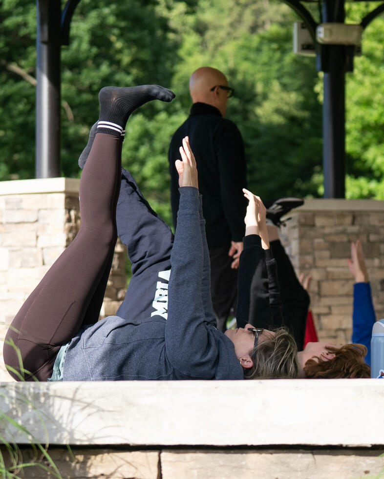Core Work Participants performing leg lifts during a mat Pilates sequence.