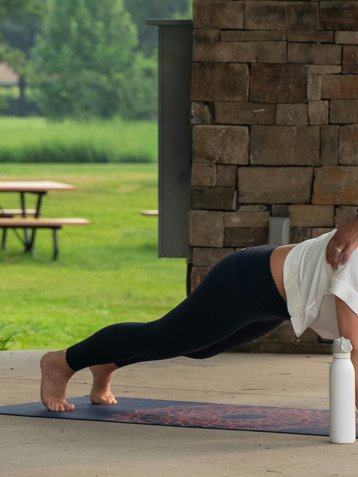 Instructor guiding participants planking form.