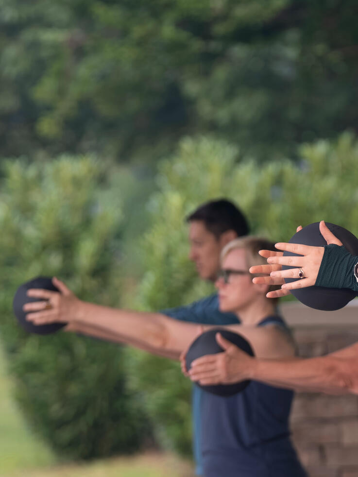 Mat class participants working with the ball.