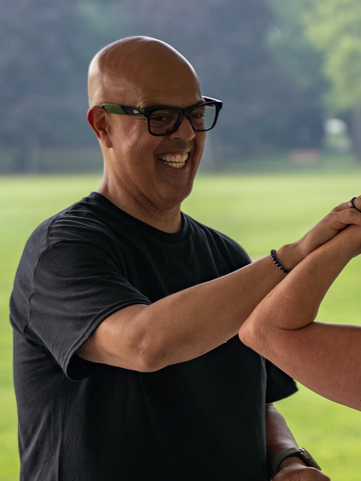 Rafael Jimenez enjoying a moment while guiding a participants form.