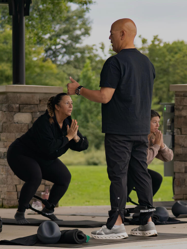 Participants doing lower body work with the ring.